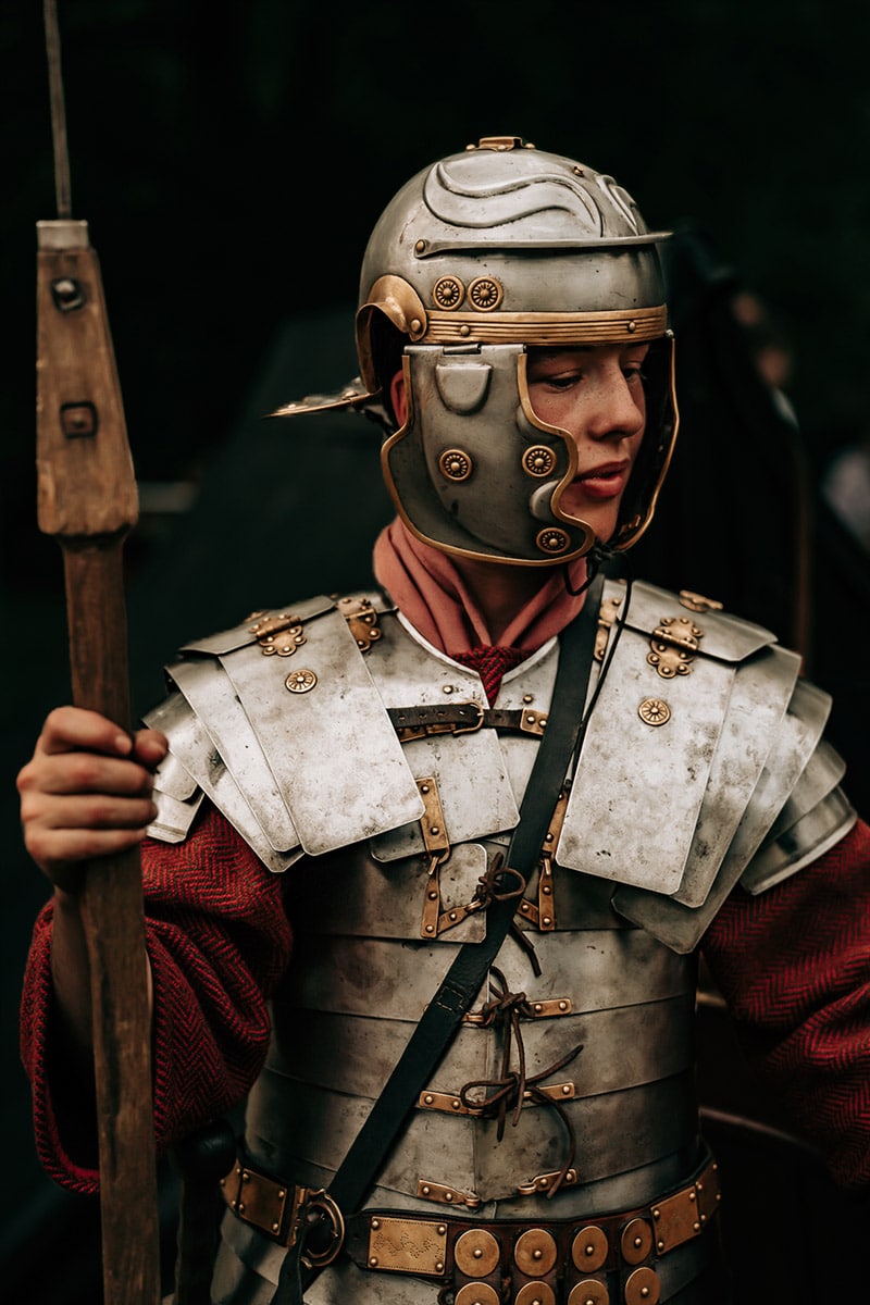 a man in a garment holding a spear